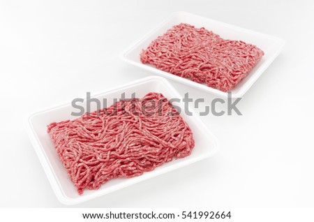 Raw beef minced meat
  in a white polystyrene tray isolated on a white background. 