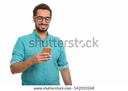 Young happy Indian man using mobile phone isolated against white background