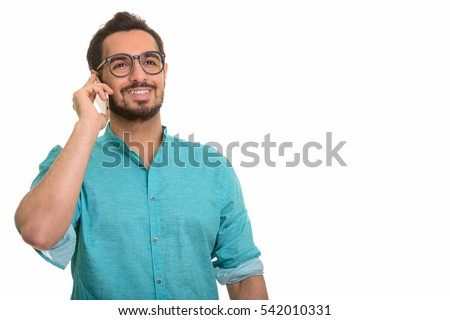 Young happy Indian man talking on mobile phone isolated against white background