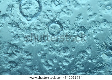 Asteroid craters, abstract texture background. Ice on winter window, macro, selective focus. Suitable as a backdrop for the projects on art, creativity, imagination and design.