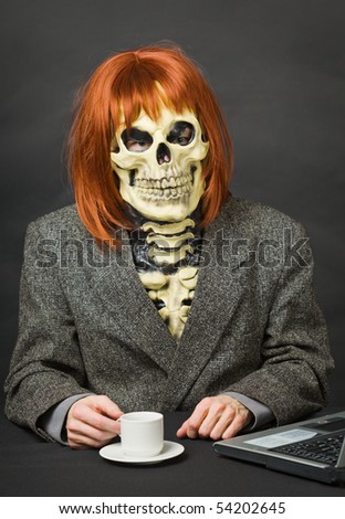 Horrible man - a skeleton with red hair drinking coffee on dark background