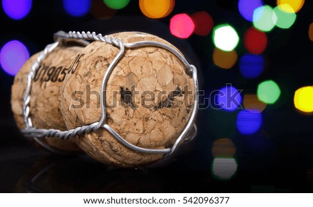 Champagne cork with the shape of Malaysia burnt in and colorful blurry lights in the background.(series)