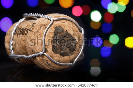 Champagne cork with the shape of Uruguay burnt in and colorful blurry lights in the background.(series)