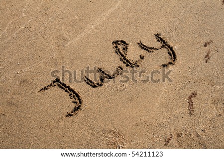 The Text string July on the sand