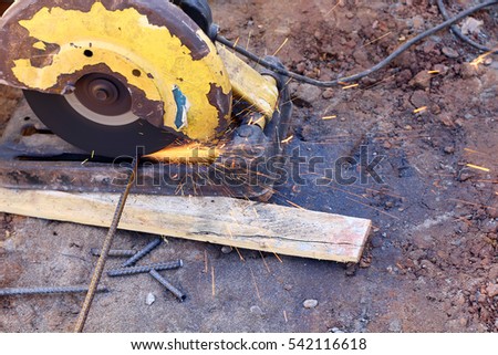 Old Power Saw cutting the steel rod, House Construction Site, Laos