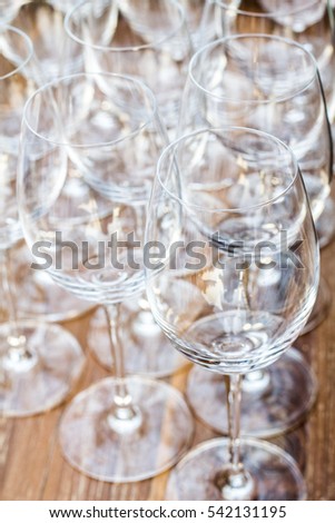 Wine glasses on the wood table background