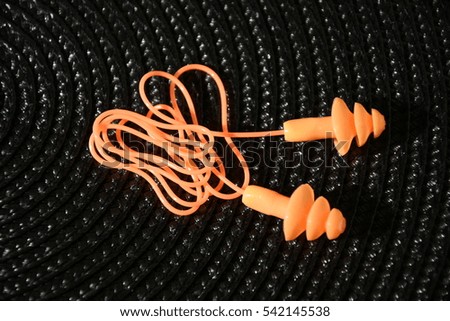 earplugs isolated on dark background