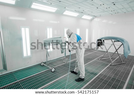 Worker painting a car parts in a paint booth, Royalty-Free Stock Photo #542175157