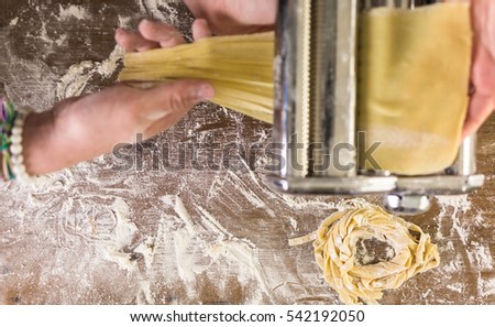 Preparing home made pasta with pasta maker.
