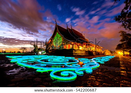 Amazing Temple Sirindhorn Wararam Phuproud in Ubon Ratchathani Province at twilight time,Thailand.Thai temple  with grain and select white balance.Night sky effect for Long exposure photo taken.