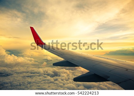 Vintage color tone of Morning sunrise with Wing of an airplane. Photo applied to tourism operators. picture for add text message or frame website. Traveling concept
