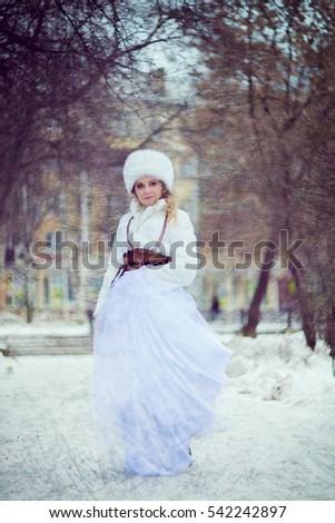 Girl, Blonde in a white fur coat and hat, in fluffy white skirt . Winter photo session in retro style stylized picture