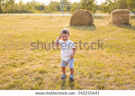 Little boy in the countryside. Toddler playing active games outdoors. The concept of childhood.