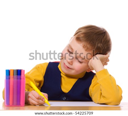 Boy drawing picture at table isolated on white