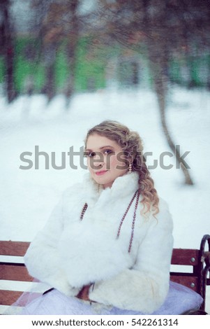 Girl, Blonde in a white fur coat with a Muff. Winter photo session in retro style stylized picture