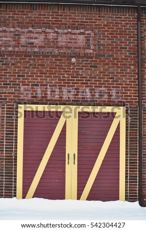 In a Former Life This Building Had a Different Purpose - Brick Wall With Old Writing - Yellow Framed Doors