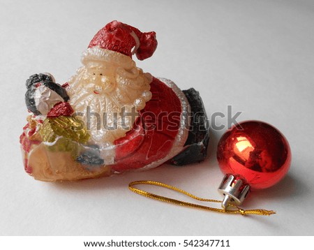Candle of wax in the form of Santa Claus and Christmas toy ball
