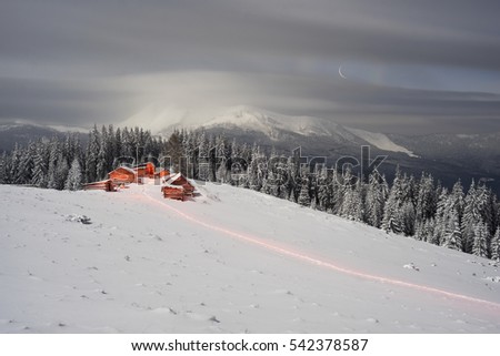 Christening on Mount Kukul. View of the houses of the shepherds in the background of harsh mountain scenery and extreme cold. The lighting creates a beautiful color picture of a fairy-tale