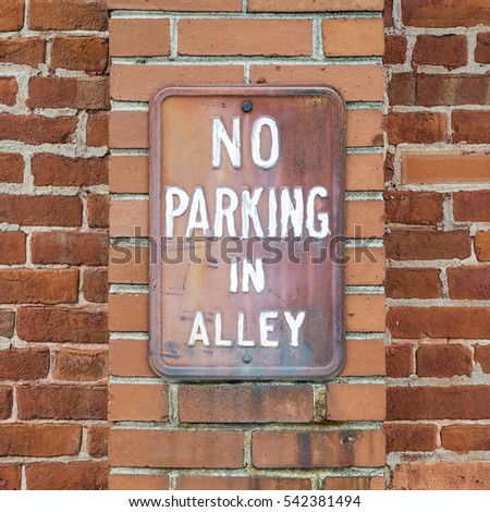 Exterior Brick Wall with No Parking in Alley Sign