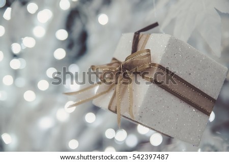 white Christmas gift box  with gold ribbon  and copyspace for your greeting or wishes