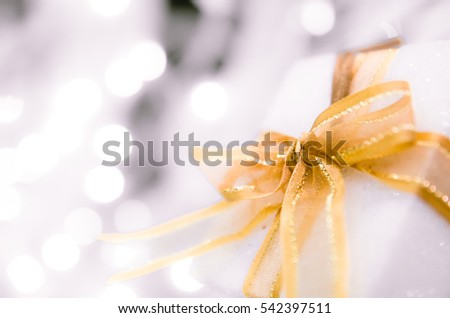  white Christmas gift box  with gold ribbon  and copyspace for your greeting or wishes