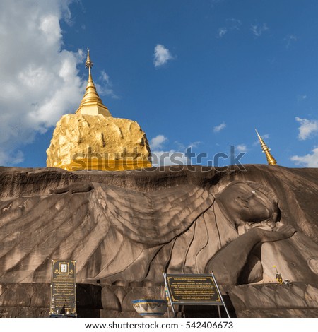 golden pagoda with buddha carved stone at wat tham pha daen in sakon nakhon thailand