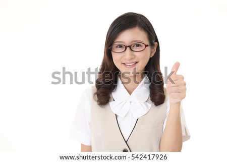 Smiling business woman with thumbs up