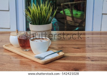 coffee and tea  in the cup on wooden table - vintage color effect