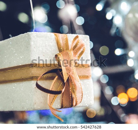 white Christmas gift box  with gold ribbon  and copyspace for your greeting or wishes