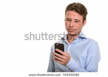 Handsome Caucasian businessman using mobile phone isolated against white background