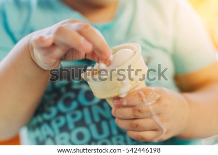 Cute happy baby girl are eating ice cream in summer. Picture for concept of sweet ,fat ,obesity and diabetes in children.Soft focus. 