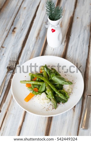Asparagus salad with carrot on white plate