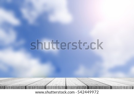 wooden tabletop with blurred of blue sky background use for products or something display