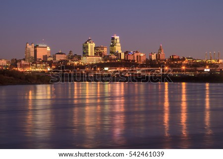 A view of the Kansas City skyline at twilight with reflections in the Missouri River