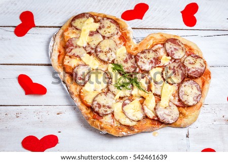 Pizza heart shaped .Concept of romantic love for Valentines Day