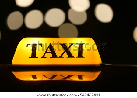 Taxi car on night street, close up view