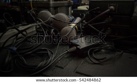 a few microphones in sound studio with wires