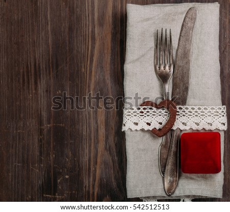 Valentine's holiday table vintage setting celebration place setting for dinner decorations on dark wooden background Copy space Top view
