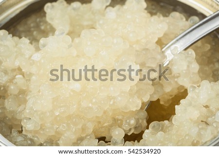 salty white caviar of halibut with spoon in tin close up