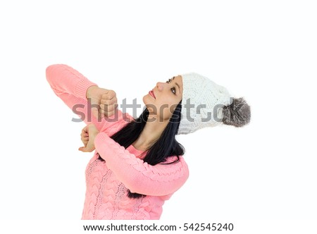 Beautiful girl in white knit hat and pink sweater isolated on white background. 