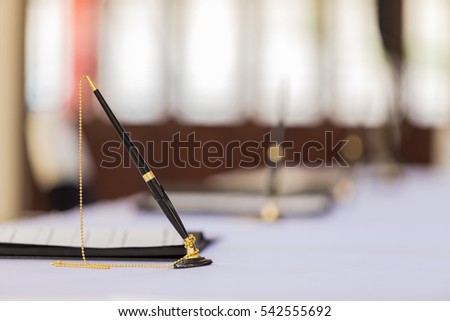Desk pen stand for signing contracts.With copy space.