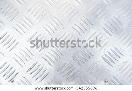 Aluminium list or Industrial shiny metal silver list with rhombus shapes. Abstract background of metallic carpet. Steel diamond plate texture.