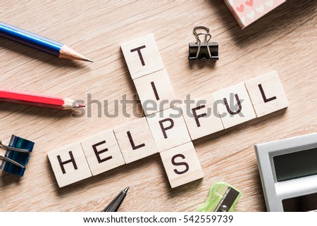 Crossword puzzled with blocks spelling helpful and tips words Royalty-Free Stock Photo #542559739