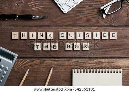 Thinking outside the box concept spelled with game elements