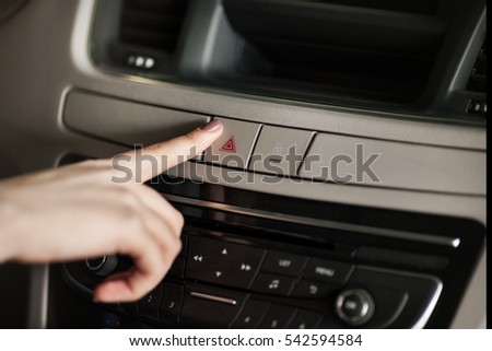 woman pushes a button in the car