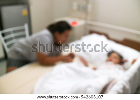 Blurred background sick girl lying in bed in hospital.