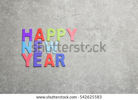 happy new year colorful wording by color wooden on gray  background and space for fill any text.