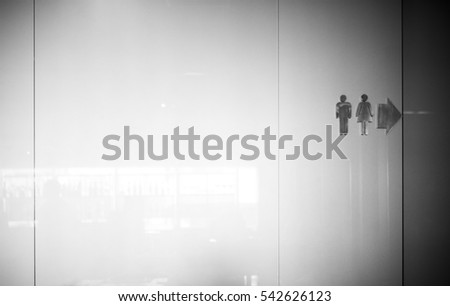 Sign and symbol of man and woman on the glass wall in hotel.