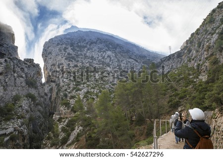 Visitors taking pictures at the begining of Caminito del Rey path, Malaga, Spain. Landscape with hills canyon full of morning mist 