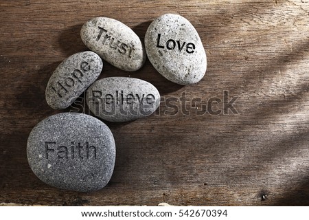 pebbles or stone with inspirational text Faith, trust, believe, hope and love  Royalty-Free Stock Photo #542670394